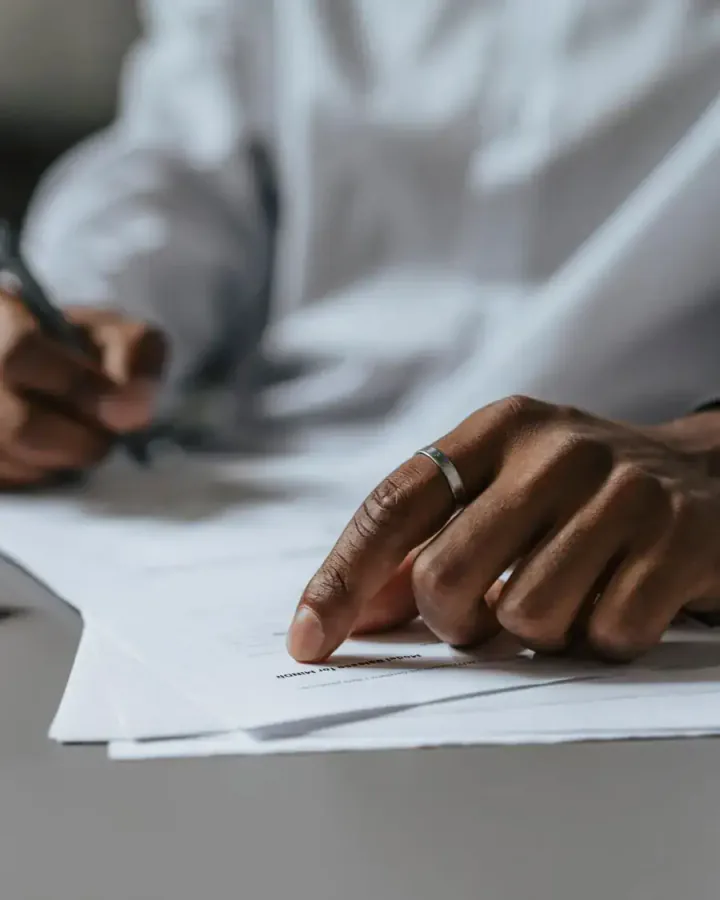 Dokumentgennemgang med pen og juridiske papirer på et skrivebord